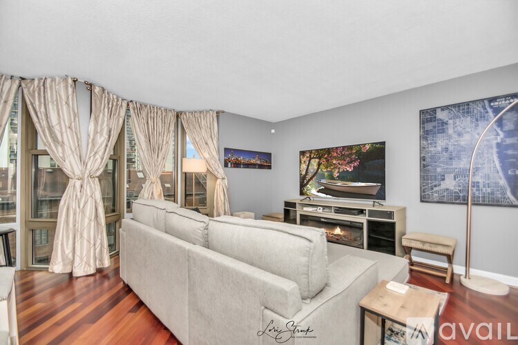 A living room with a grey couch and a television.