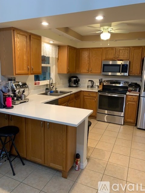 A kitchen with wooden cabinets and a white countertop.