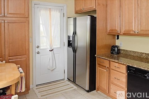 A kitchen with wooden cabinets and a white door.