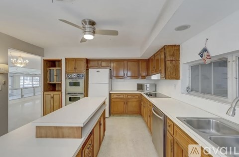 A kitchen with wooden cabinets and a white countertop.