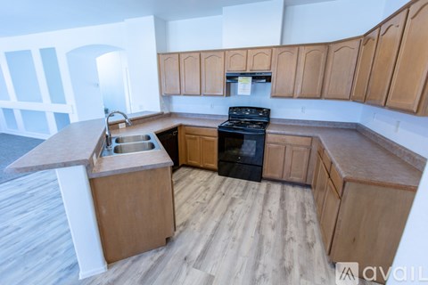 A kitchen with wooden cabinets and a black stove top oven.