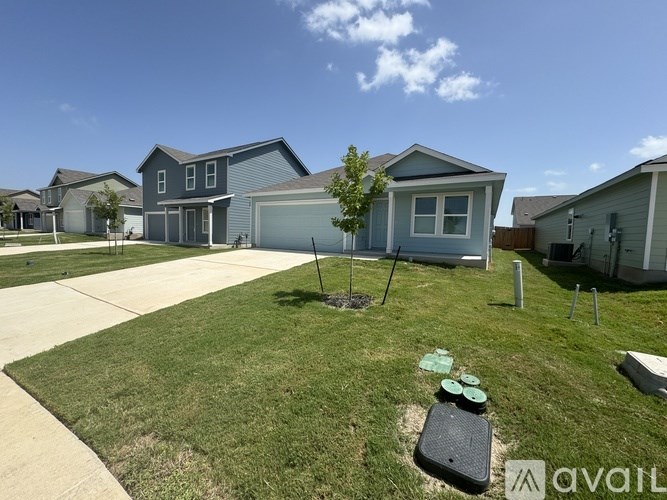 A sunny day at a residential area with houses and a clear blue sky.