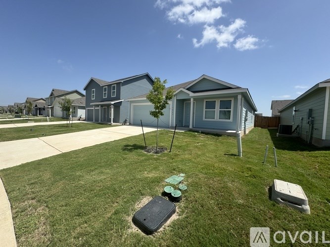 A sunny day at a residential area with houses and a lawn.