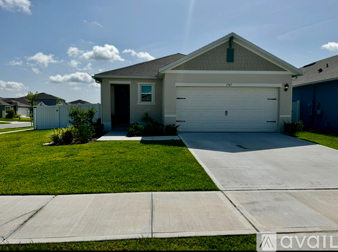 A house with a garage and a driveway in front.