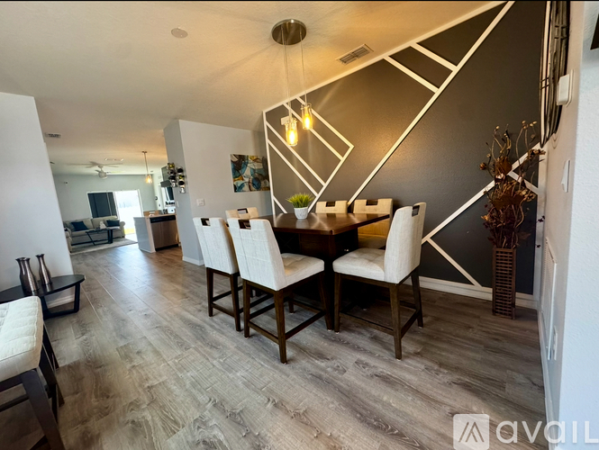 A dining room with a wooden table and chairs.