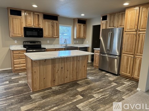 A kitchen with wooden cabinets and a central island.