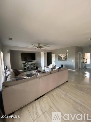 A living room with a large couch and a flat screen TV.