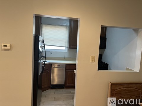 A kitchen with a dishwasher and a refrigerator.