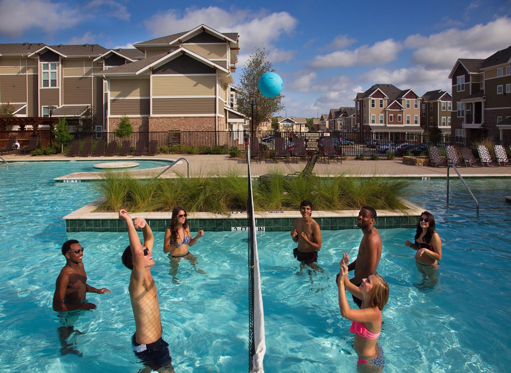 a group of people playing in a swimming pool