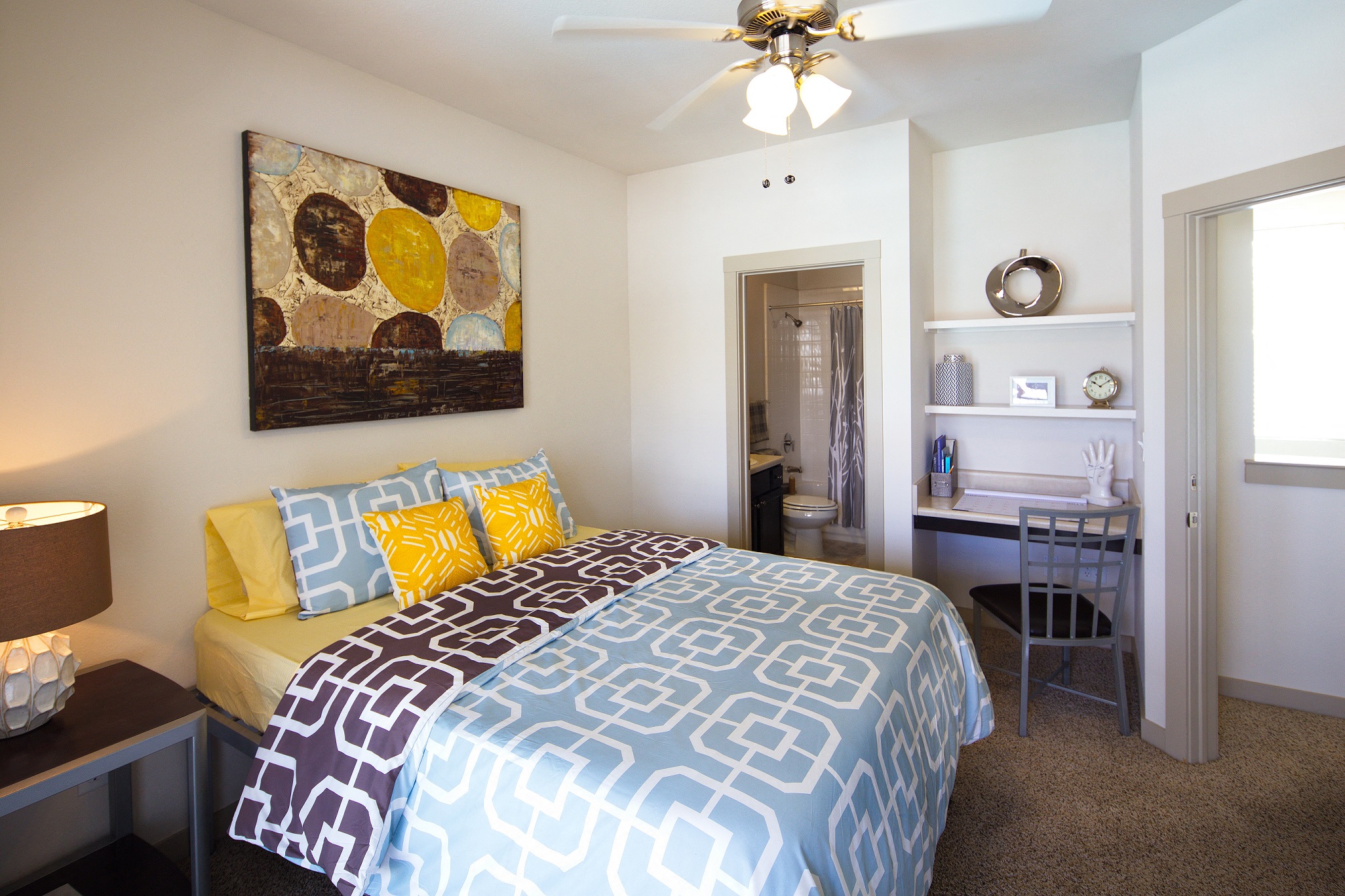 a bedroom with a large bed and a ceiling fan