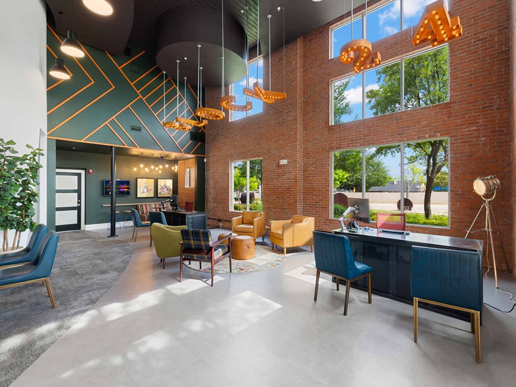 the lobby of a building with a reception desk and chairs