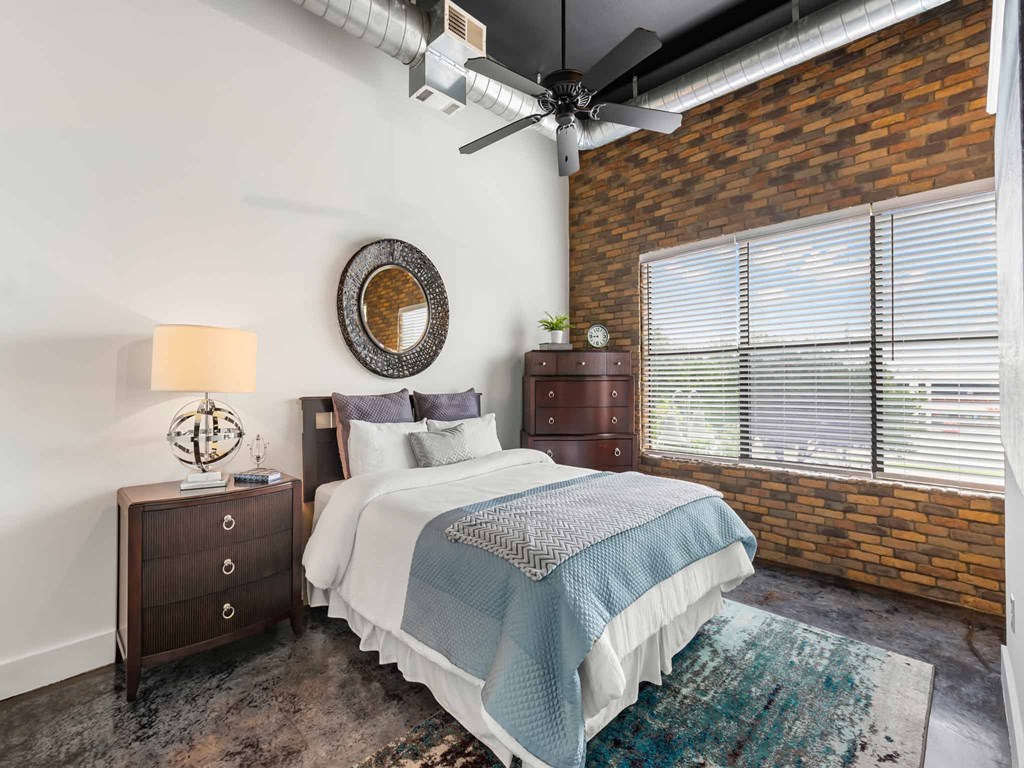 a bedroom with a bed and a ceiling fan
