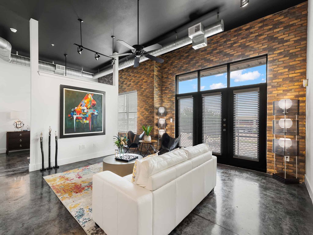 a living room with a white couch and a large window