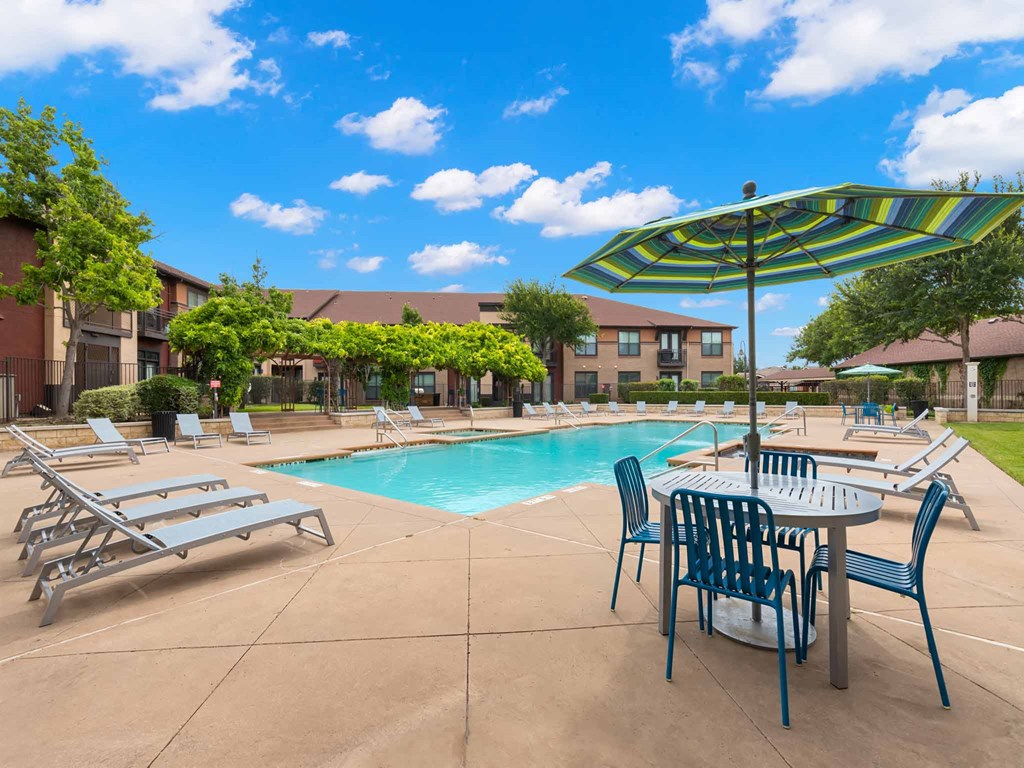 our apartments offer a swimming pool with tables and chairs