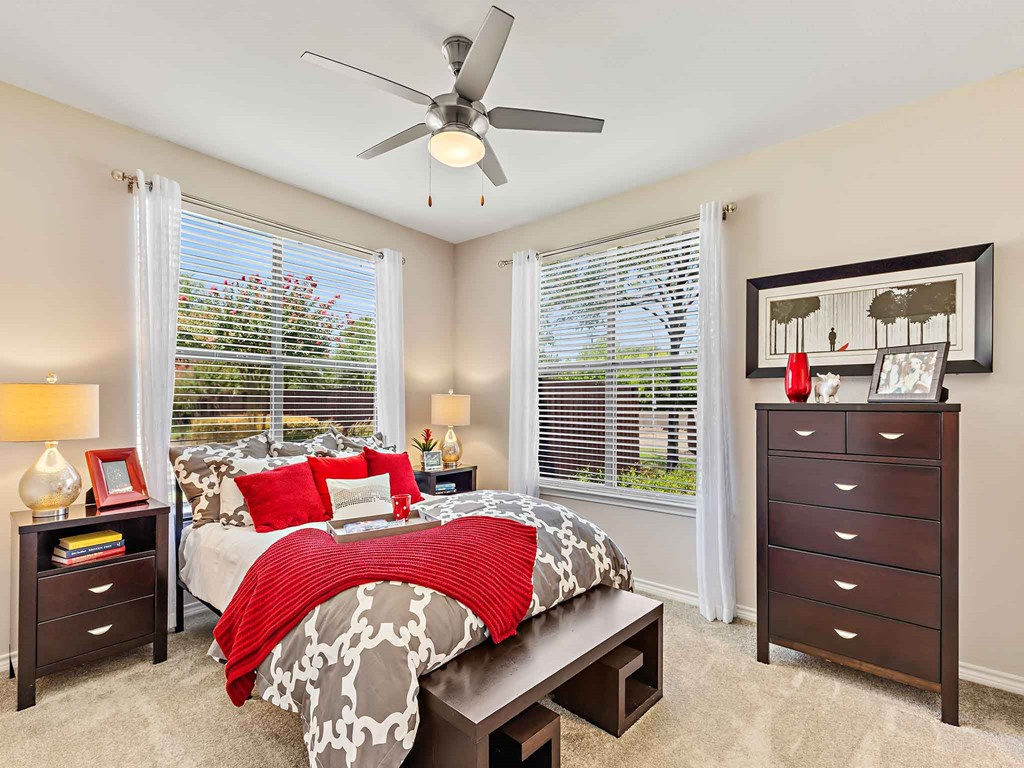 a bedroom with a bed and a ceiling fan