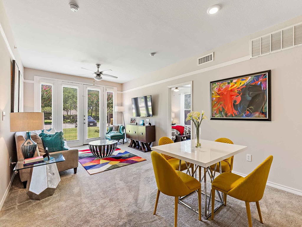 a living room with a table and chairs