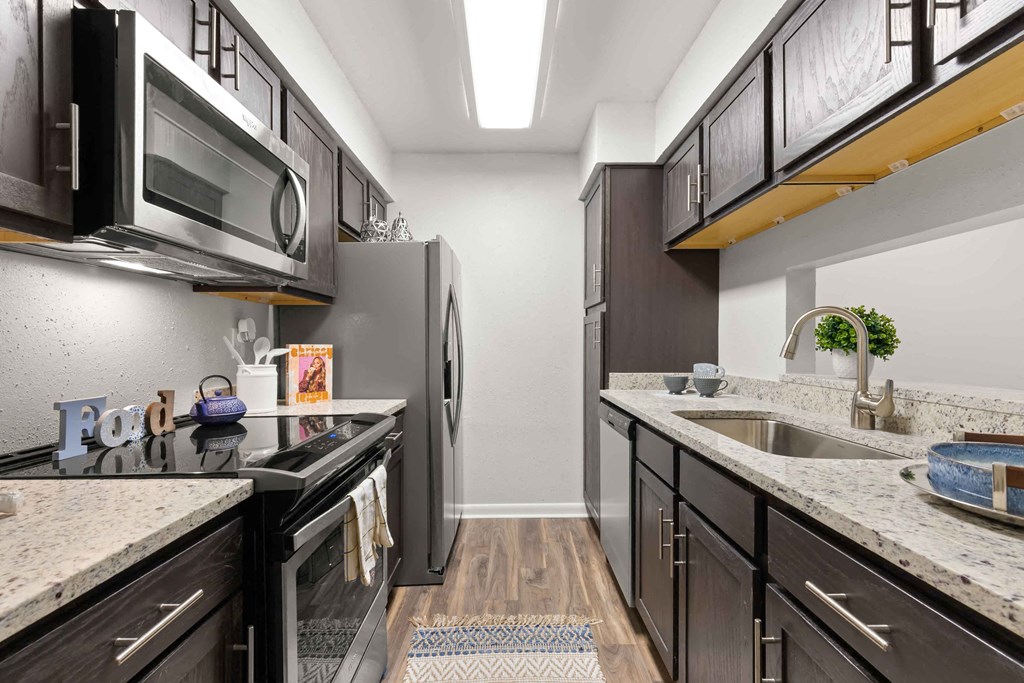 a kitchen with stainless steel appliances and granite counter tops