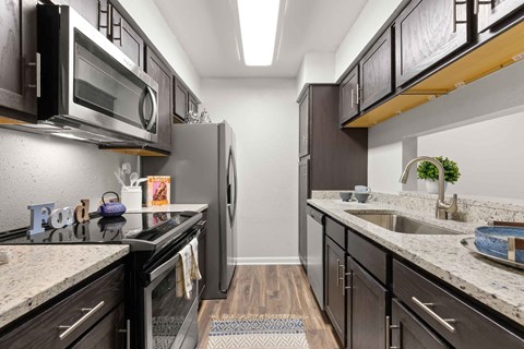 a kitchen with stainless steel appliances and granite counter tops