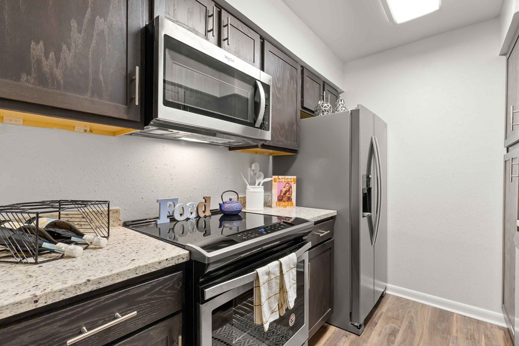 a kitchen with stainless steel appliances and a microwave