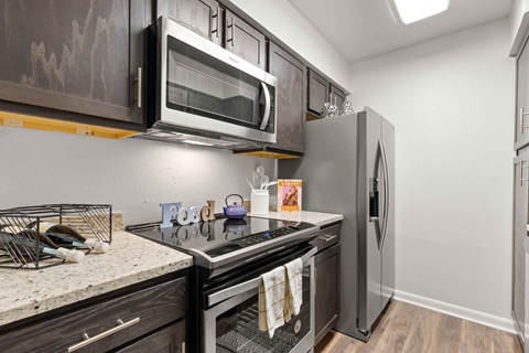 a kitchen with stainless steel appliances and a microwave