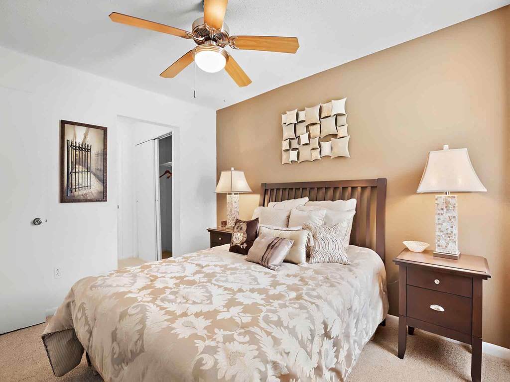 a bedroom with a bed and a ceiling fan