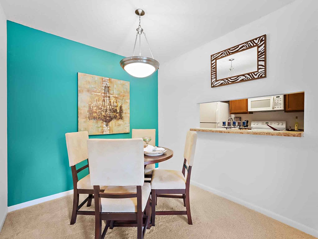 a dining room with a table and chairs