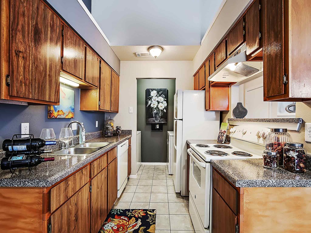 a kitchen with a stove refrigerator and sink
