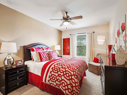 a bedroom with a bed and a ceiling fan