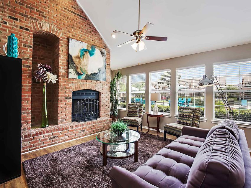 a living room with a brick fireplace and a couch