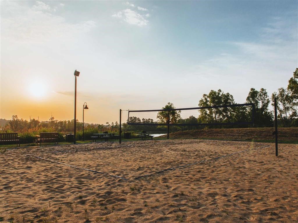 a volleyball court on the beach at sunset
