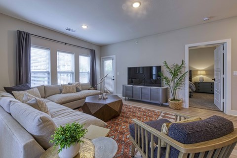 A living room with a grey couch and a wooden coffee table.
