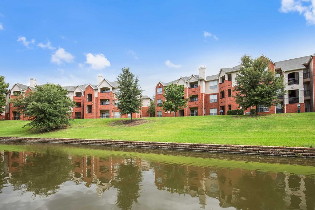 an image of an apartment building overlooking a body of water