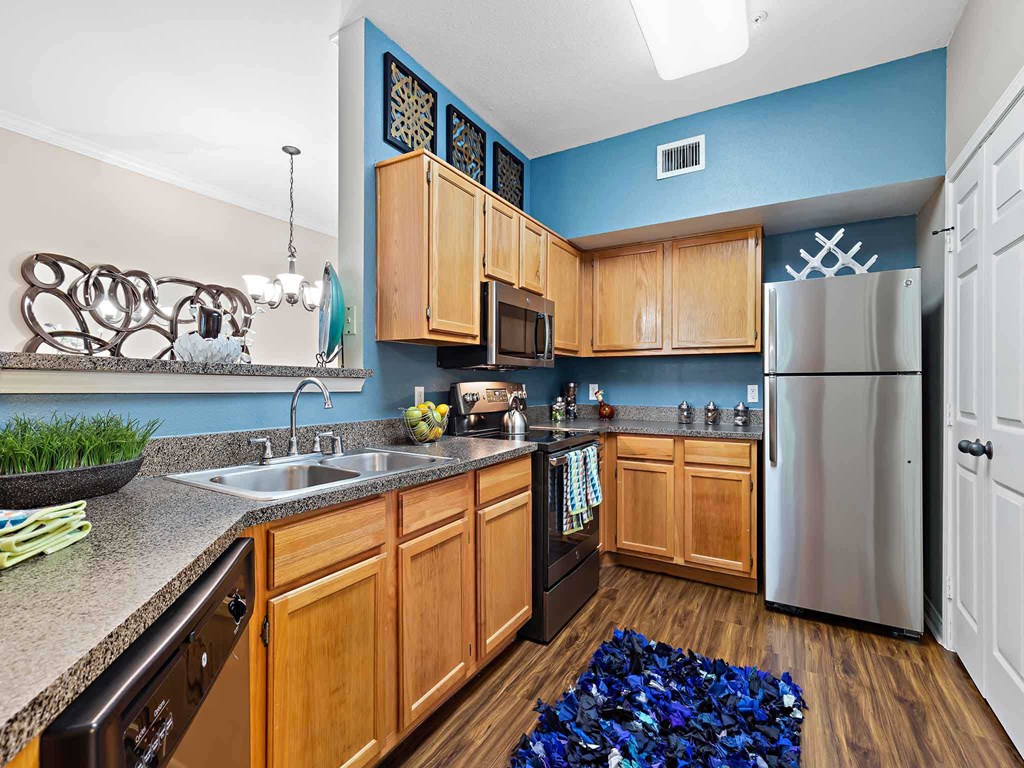 a kitchen with stainless steel appliances and wooden cabinets