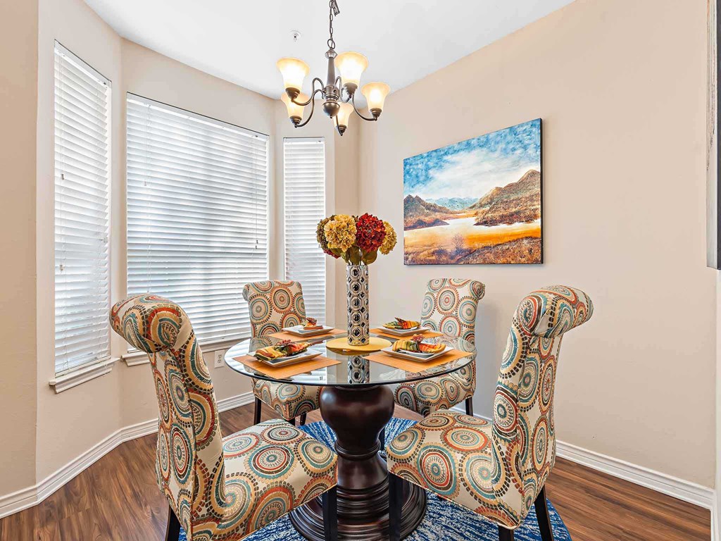 a dining room with a table and chairs