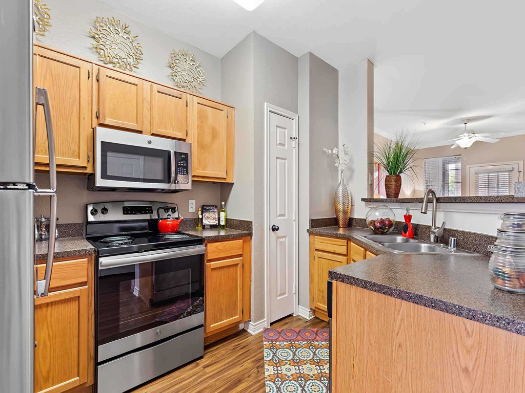 a kitchen with stainless steel appliances and wooden cabinets