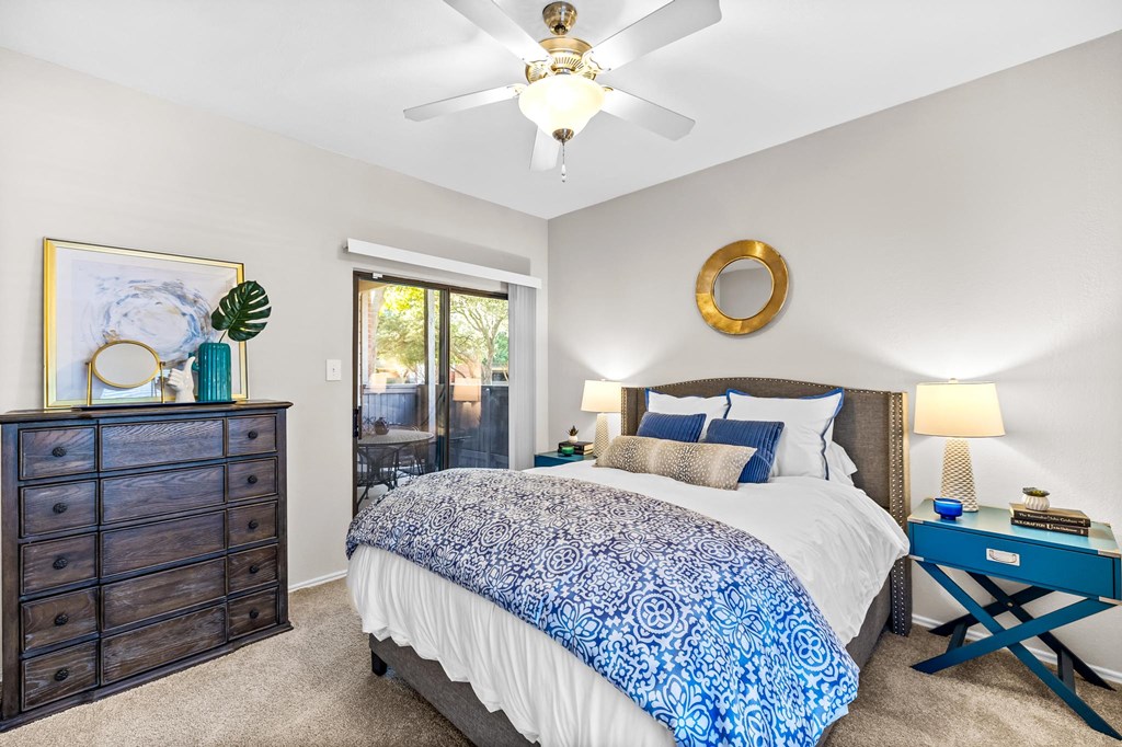 a bedroom with a bed and a ceiling fan