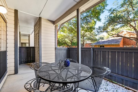 a patio with a table and chairs on it