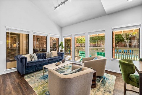 a living room with a couch and chairs and a table