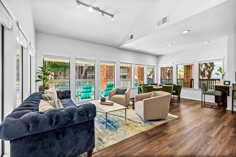 a living room with a blue couch and a rug