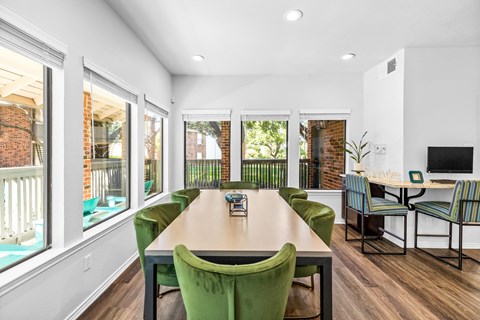 a conference room with a table and chairs and windows