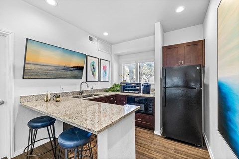 a kitchen with a counter top and a refrigerator