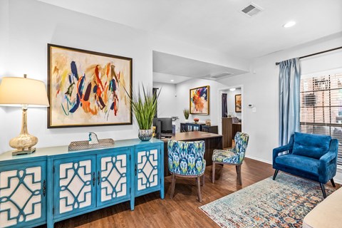 a living room with blue furniture and a dining room table