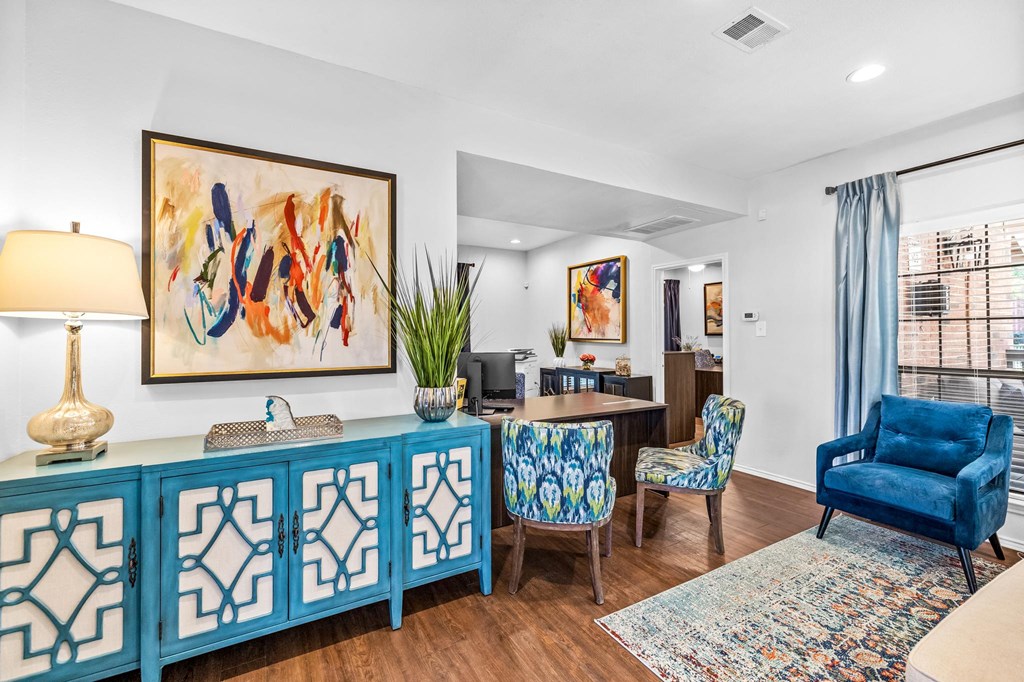 a living room with blue furniture and a dining room table