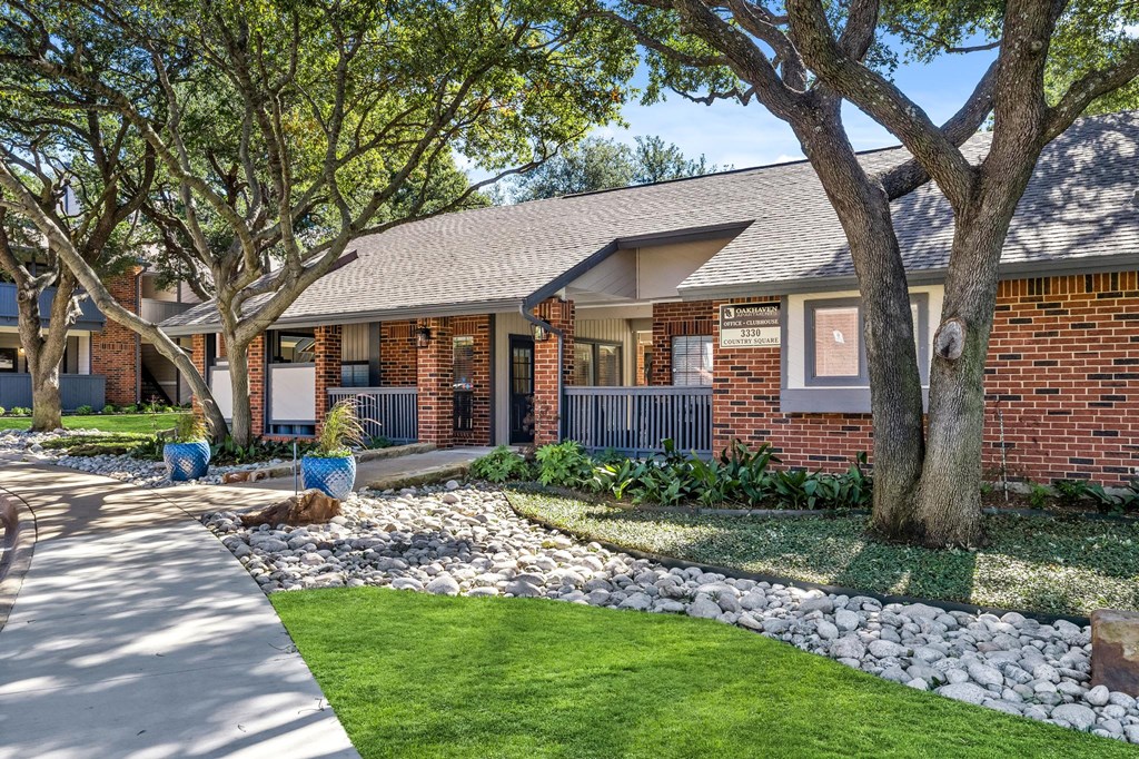 a house with a yard and trees and a sidewalk