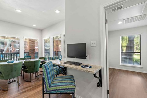 a room with a desk with a keyboard and a monitor