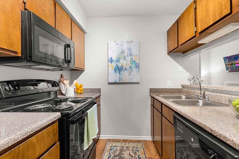 a kitchen with a stove microwave and sink