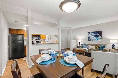 a dining room and living room with a table and chairs