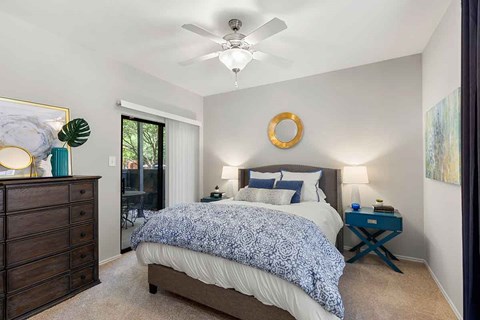 a bedroom with a bed and a ceiling fan