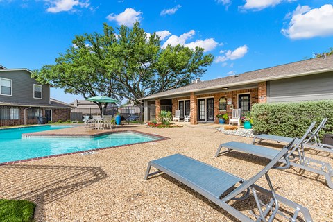 A backyard with a pool and a patio area.
