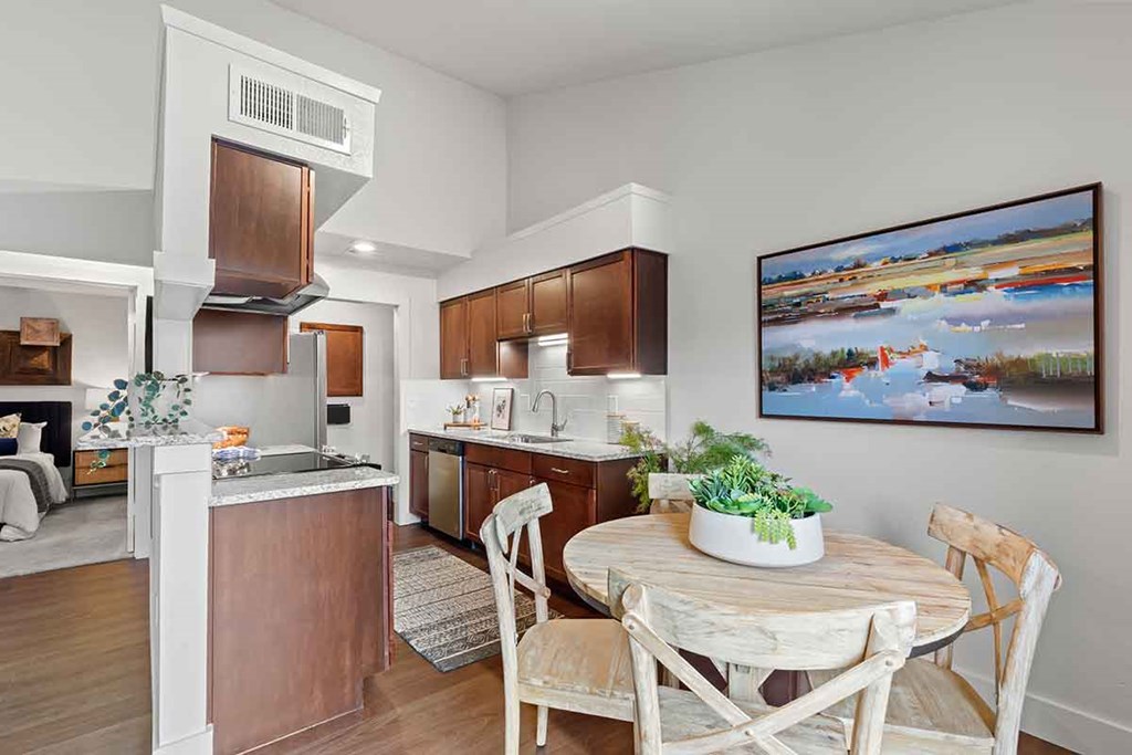 a kitchen and dining room with a table and chairs